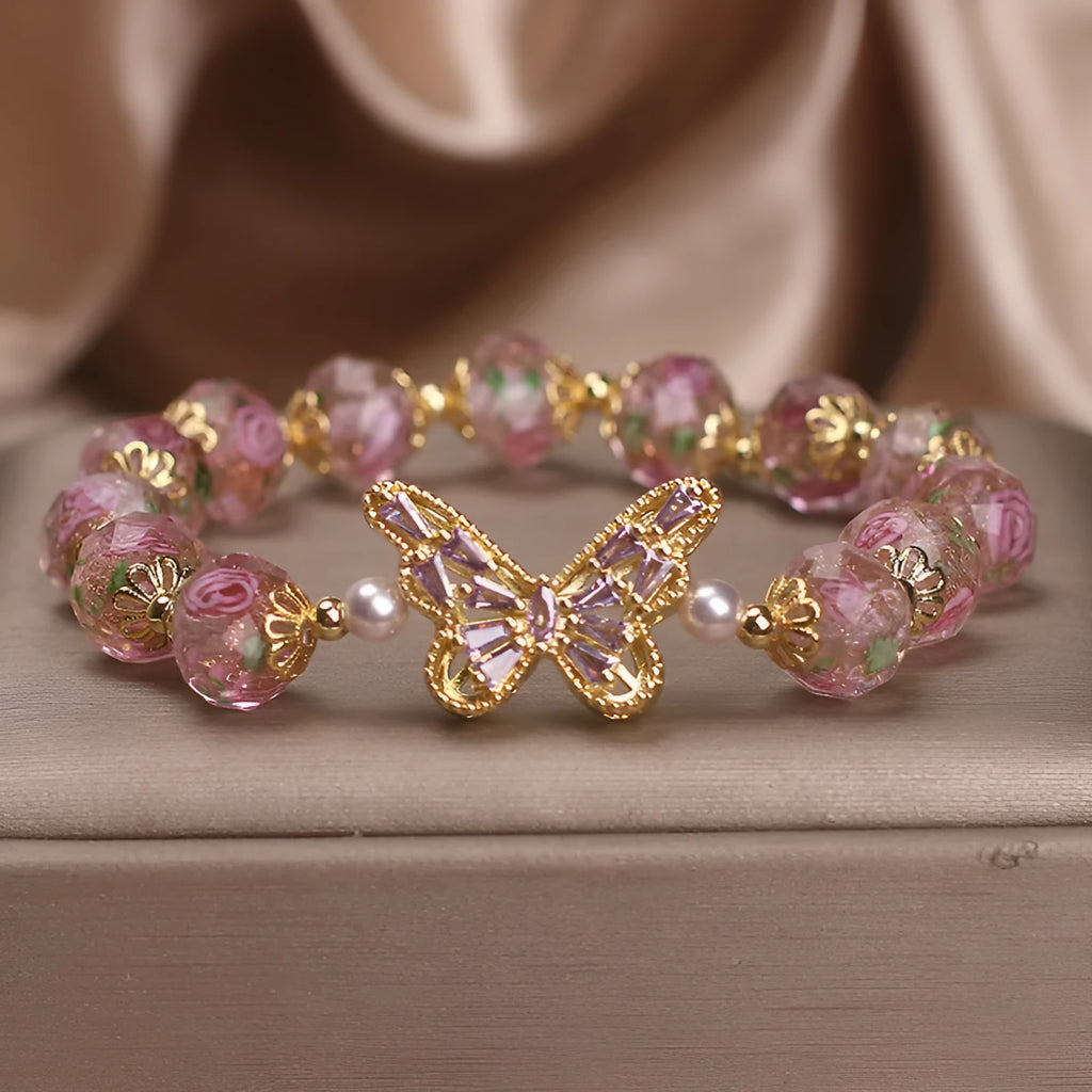 Pink crystal cherry blossom butterfly bracelet with hollow zircon accents on white background