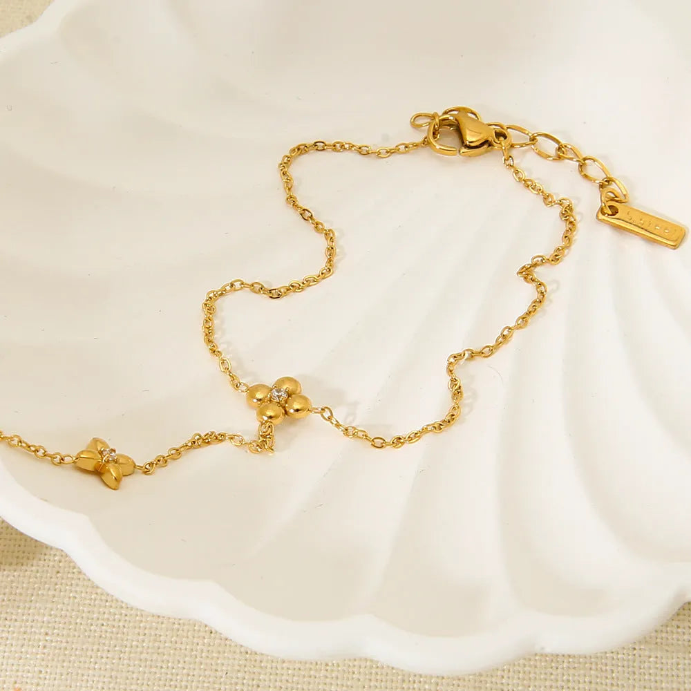 Gold geometric women's bracelet with floral and eight-pointed star design on stainless steel