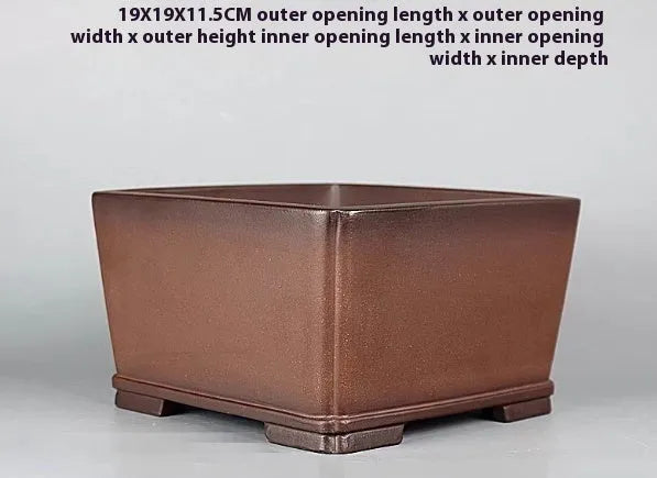 Brown handmade antique purple clay flower pot for indoor plants.