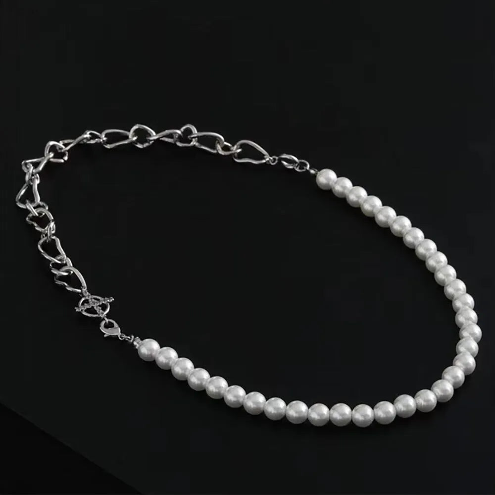 White acrylic geometric asymmetric pendant necklace on a twisted chain, shown at clavicle length.