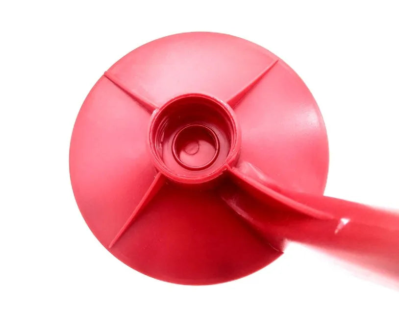 Red plastic Magic Tap soda dispenser attached to 2-liter bottle showing push-in tap mechanism