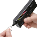 Black handheld diamond thermal conductivity meter with metal probe on a white background.