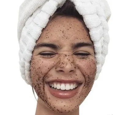 Jar of Coconut Oil Coffee Scrub exfoliating deep cleansing granules with coffee and coconut oil ingredients