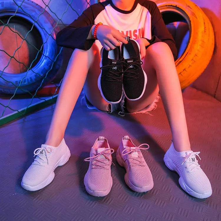 Women's white thick-soled sports shoe with woven upper and front strap