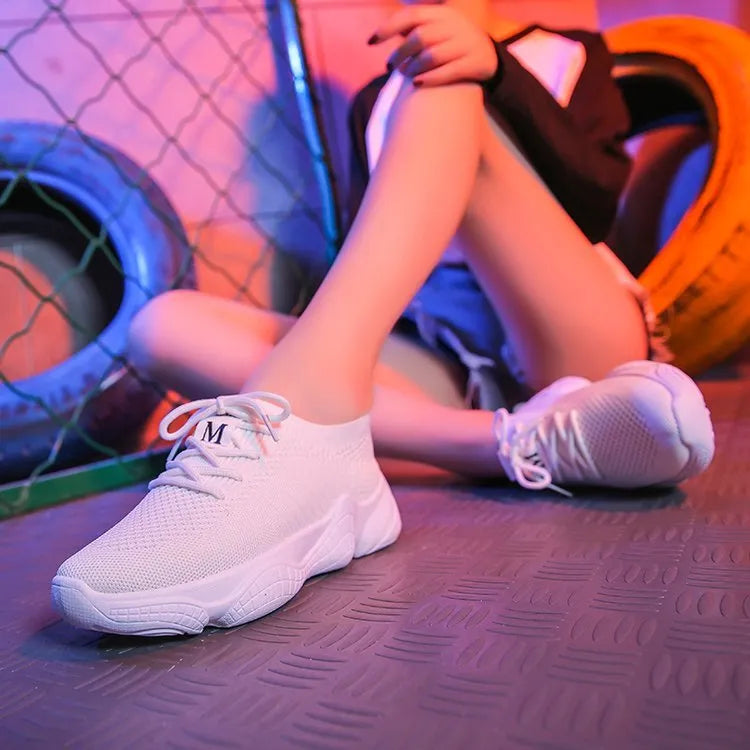 Women's white thick-soled sports shoe with woven upper and front strap