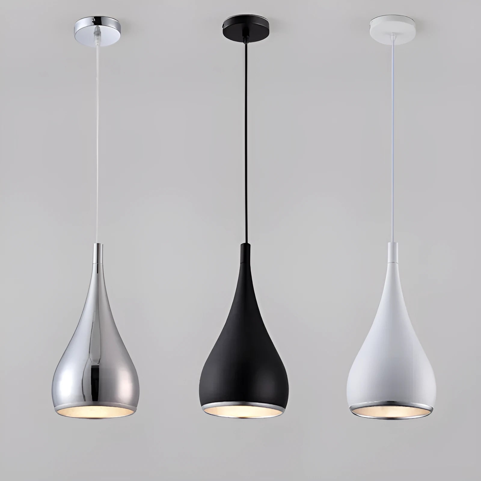 Minimalist iron pendant chandelier with three black lamp heads on a long disc fitting.
