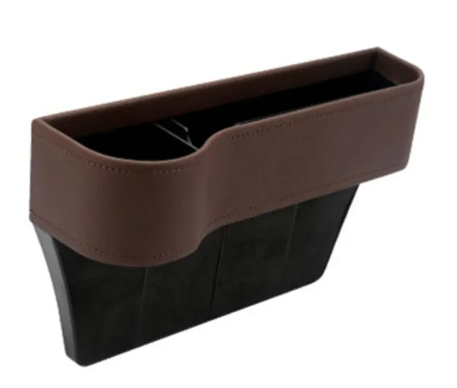 PU leather car seat gap storage box in black holding a smartphone and wallet between the console and seat