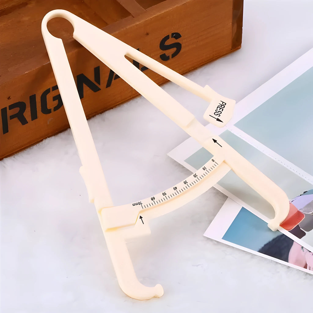 Clear acrylic body fat caliper skin fold thickness measuring instrument on a white background