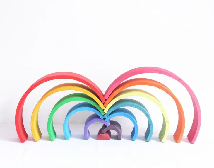 12-piece wooden arch bridge rainbow building blocks made from New Zealand pine with light lacquer finish on a flat surface