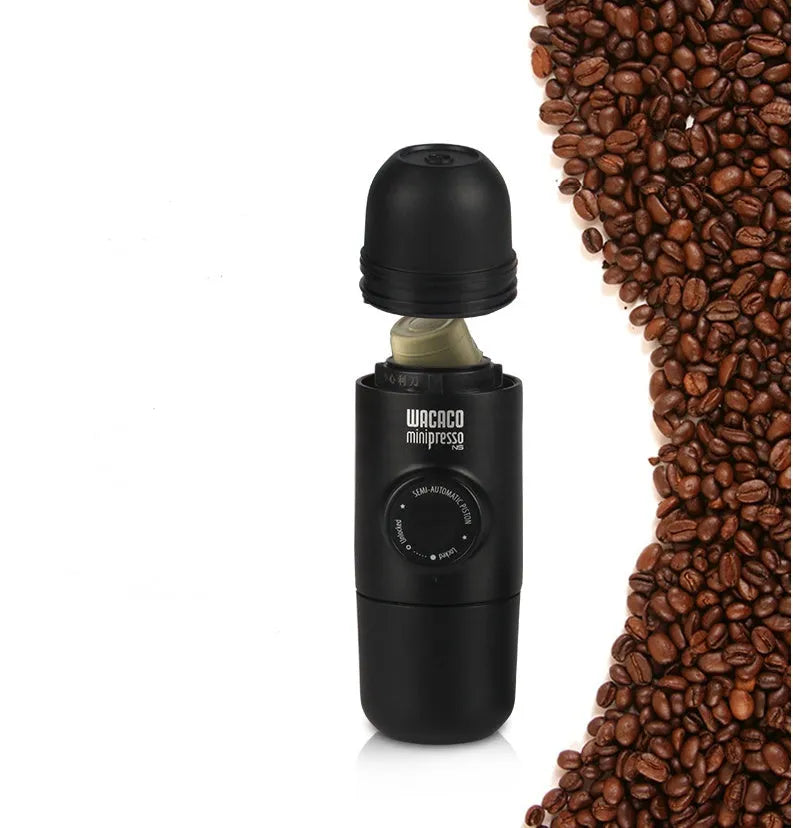 Black portable manual coffee machine measuring 6cm by 17.5cm on a table