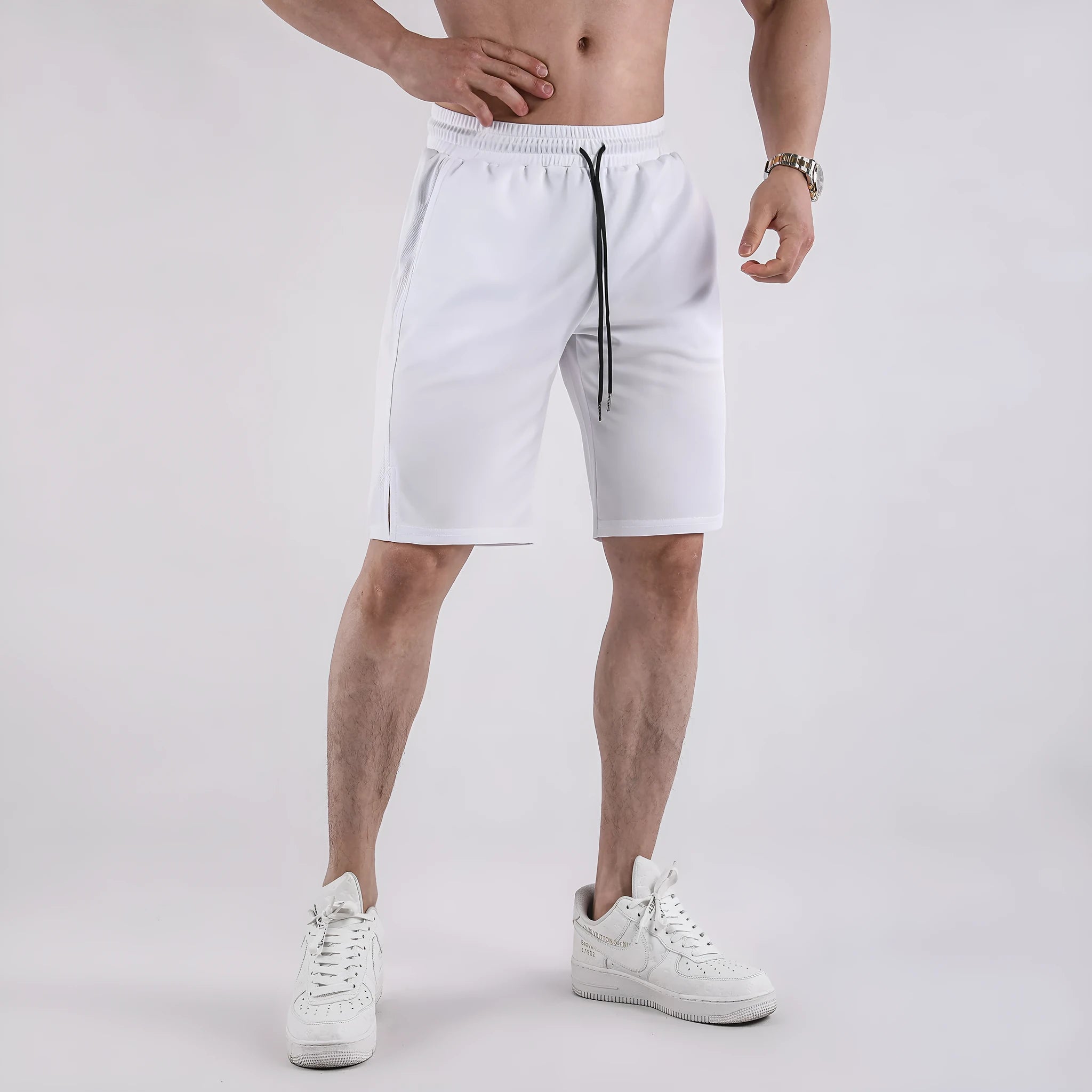 Man wearing black loose-fit quick-dry mesh sports shorts for summer.