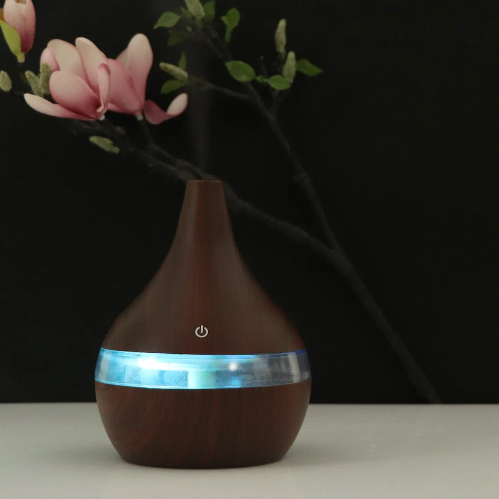 USB mini air purifier humidifier with wood grain finish in columnar shape for small rooms.