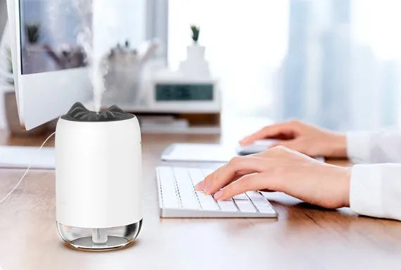 Mini USB ultrasonic humidifier 260ml with night light in turquoise green on a desk