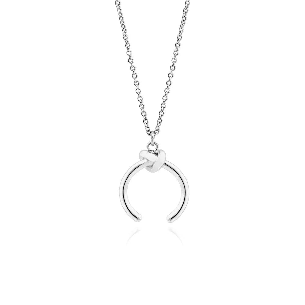 A vintage-style geometric pendant necklace with a cross chain, shown in gold and silver finishes.
