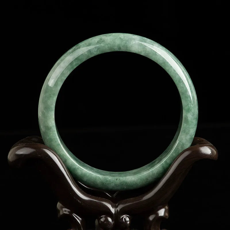 Natural emerald bean green women's bracelet on a gift box, showing simple design and deep pea green stone colour.
