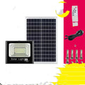 Black Cornucopia solar-powered LED flood light with remote control mounted on an outdoor wall