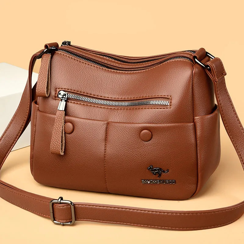 Soft black PU leather women's crossbody bag showing external pockets and a horizontal square shape.