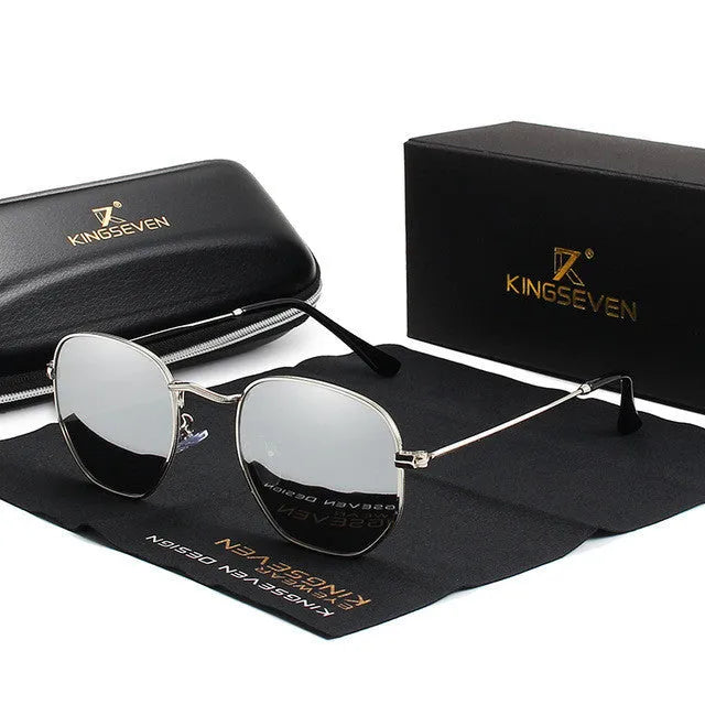 Classic round metal frame sunglasses for men in gun grey colour with UV400 lenses on a table.
