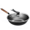 Black handmade iron wok with wooden handle, 32cm diameter.