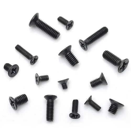 Black flat head M1.4 x 16mm laptop screws spilt from a box, showing cross slot drive and countersunk head profile.