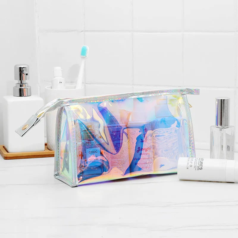 Transparent laser PVC cosmetic bag with zip closure, 22x7x14cm, on a flat surface