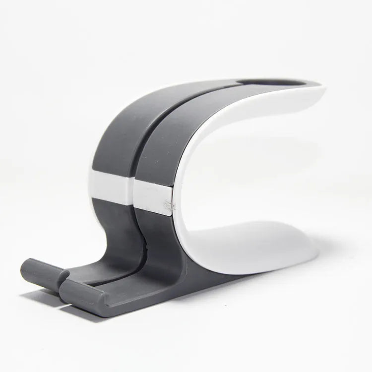 Grey Apple Watch and iPhone charging stand on desktop