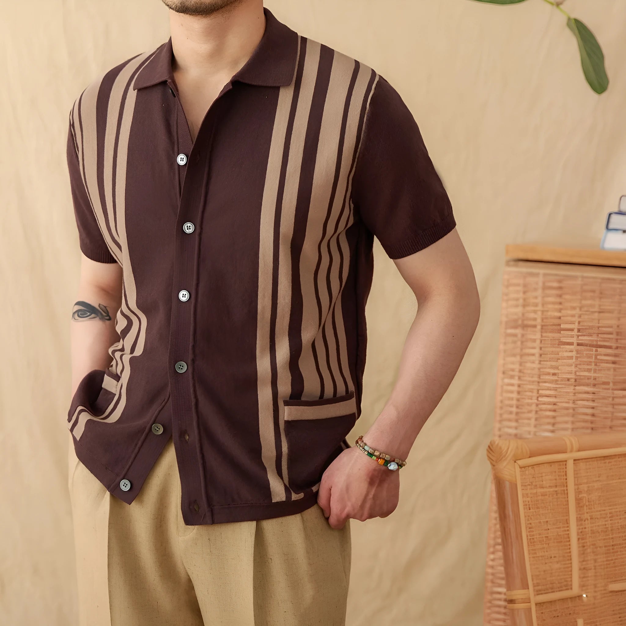 Light blue striped cotton polo cardigan with short sleeves and a lapel collar on a hanger.