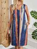 A sleeveless V-neck dress with colour block stripes on a mannequin, showing its mid-length cut.