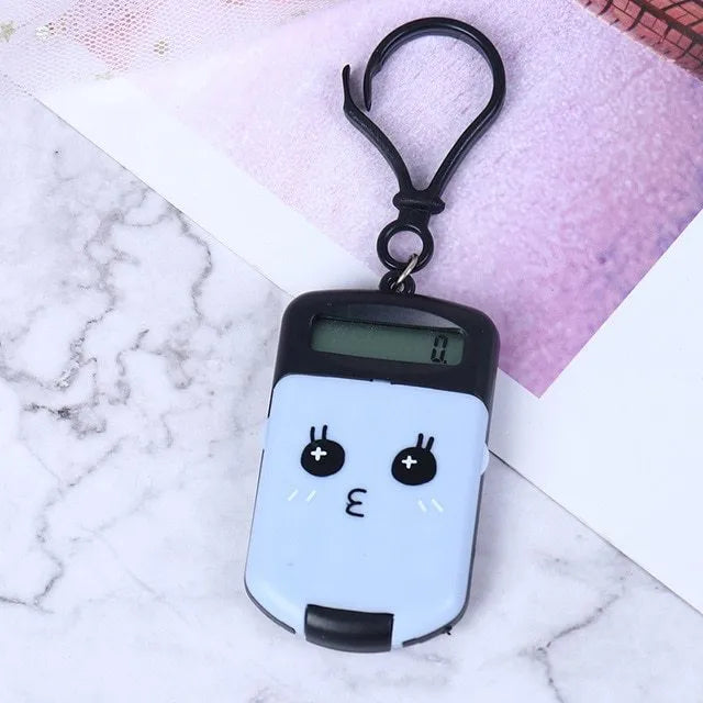 Creative cookie-shaped cute mini calculator in pink with key ring on a white background