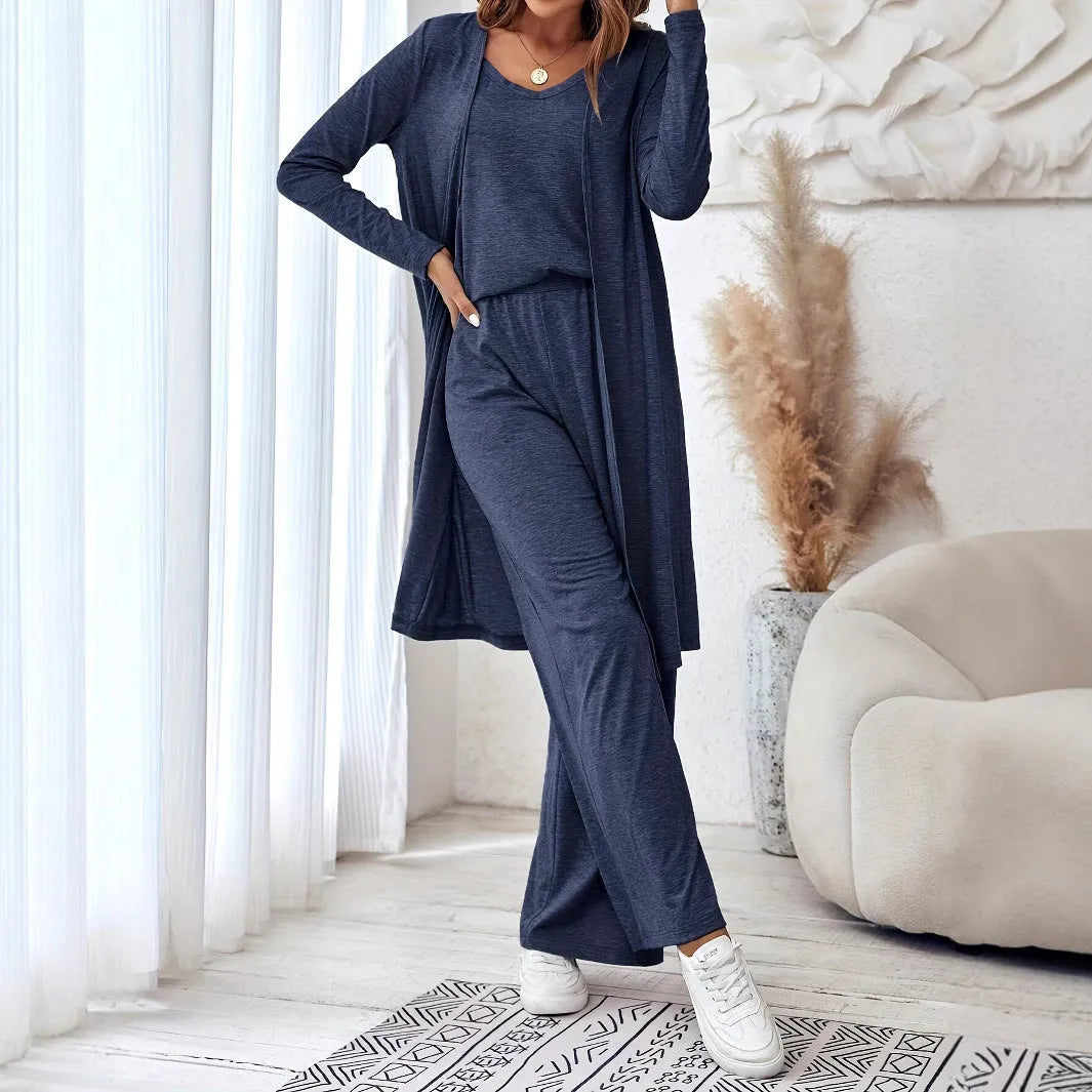 Blue women's three-piece casual suit with sling top, cardigan, trousers, and suspenders.