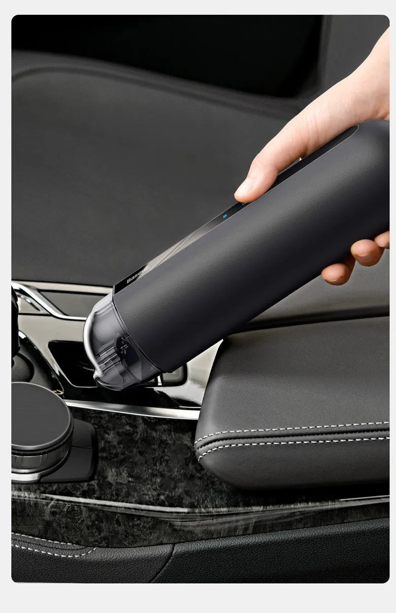 Starry sky black handheld car vacuum cleaner with a blowing hose attachment on a car seat.