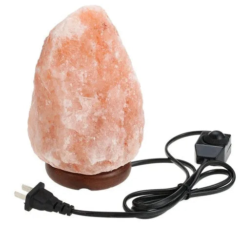 Natural rock salt crystal lamp with warm glow on bedside table, compact 10-11cm diameter