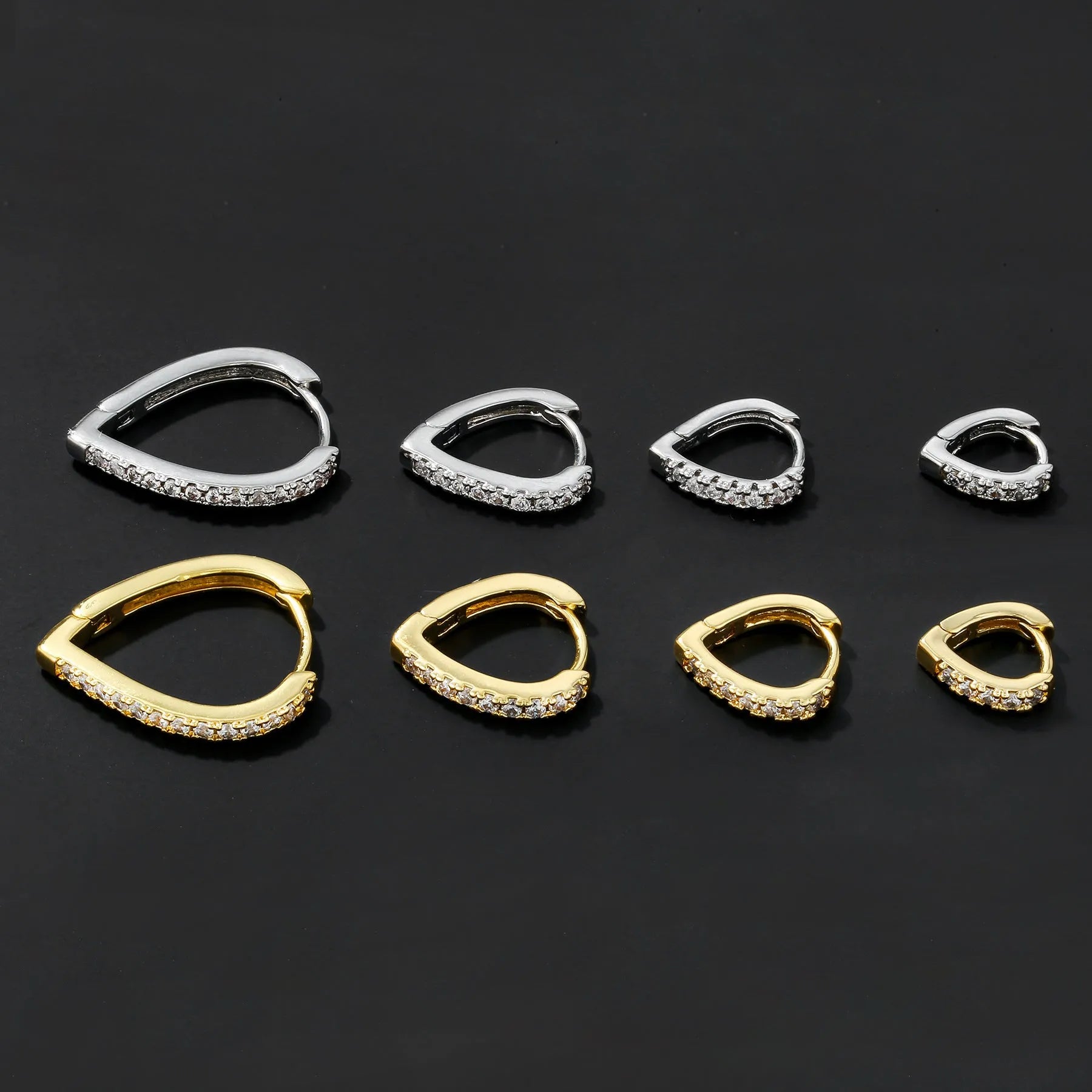 Geometric copper love heart ear clip with electroplated gold finish, shown on a white background.