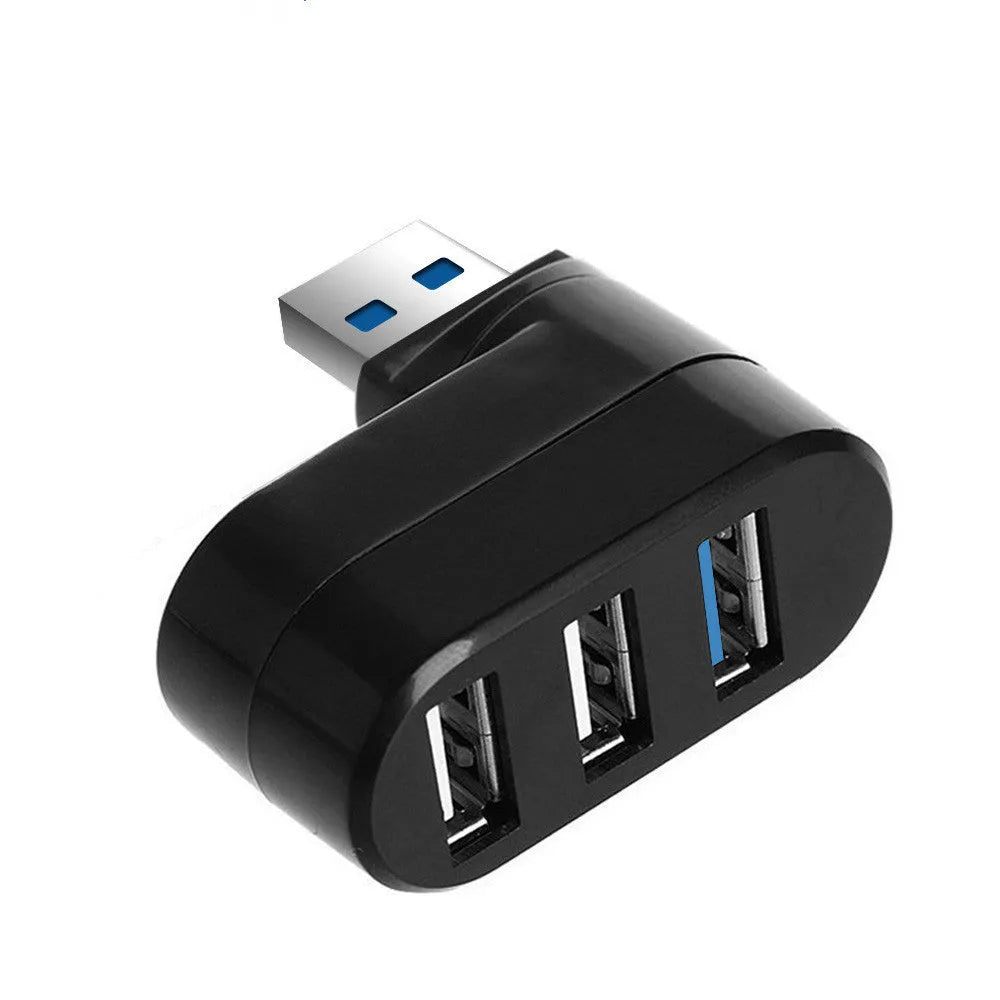 Black USB rotary splitter hub with four ports on a rotating white ABS body, shown on a desk.