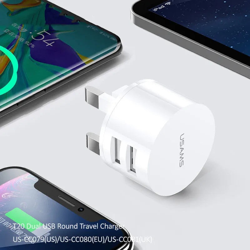 White portable universal dual USB phone charger with UK, EU, and US plugs
