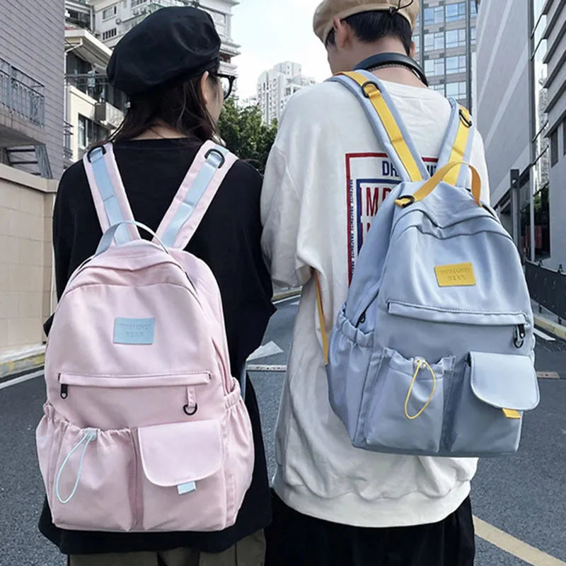 Nylon backpack school bag for junior high students, large capacity 20-35L, waterproof, with computer pocket, available in black.