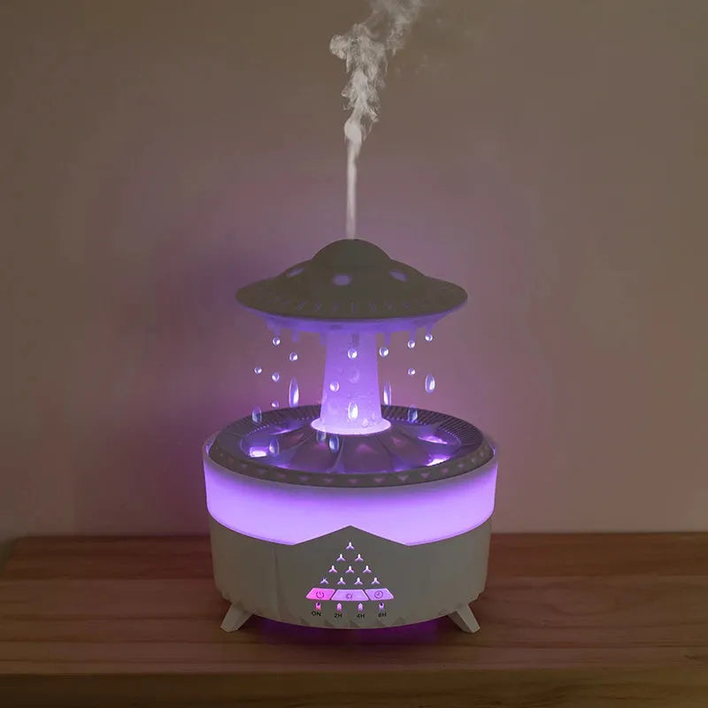 White UFO-shaped cloud humidifier with mist and soft blue night light on a wooden table