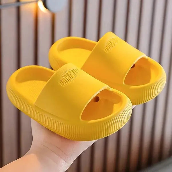 Children's mixed colour EVA slippers with textured sole, shown in blue, green, orange, pink, and yellow.