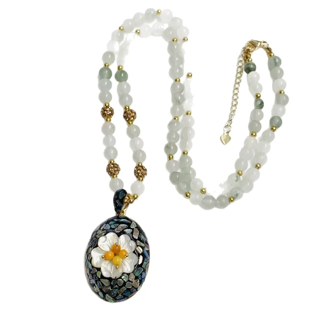 Original design mother-of-pearl lacquer shell necklace with rhinestone twist chain on display