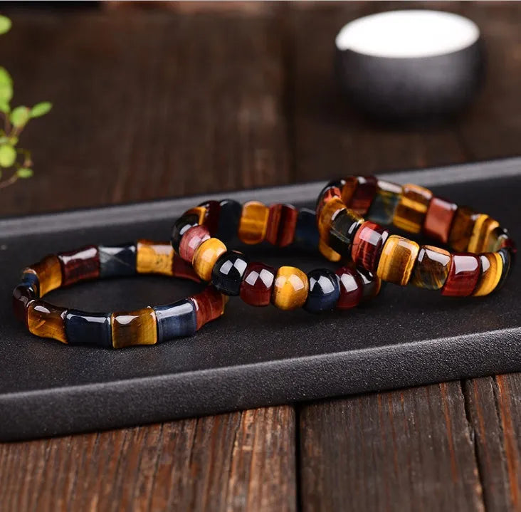 Natural tiger eye stone bracelet with round 14x10mm beads in red colour on a neutral background