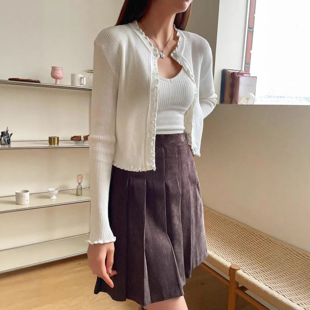 Women's white solid colour stringy selvedge cardigan with ruffled long sleeves, short length, open front design.