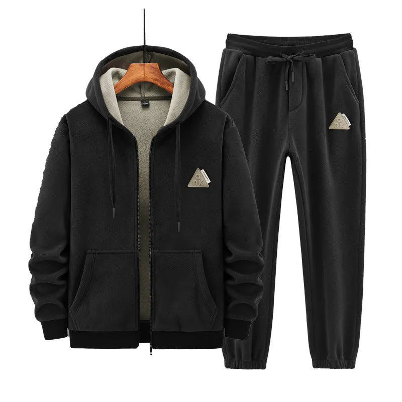 Man wearing a grey hooded sweater and matching trousers from a casual sports suit set.