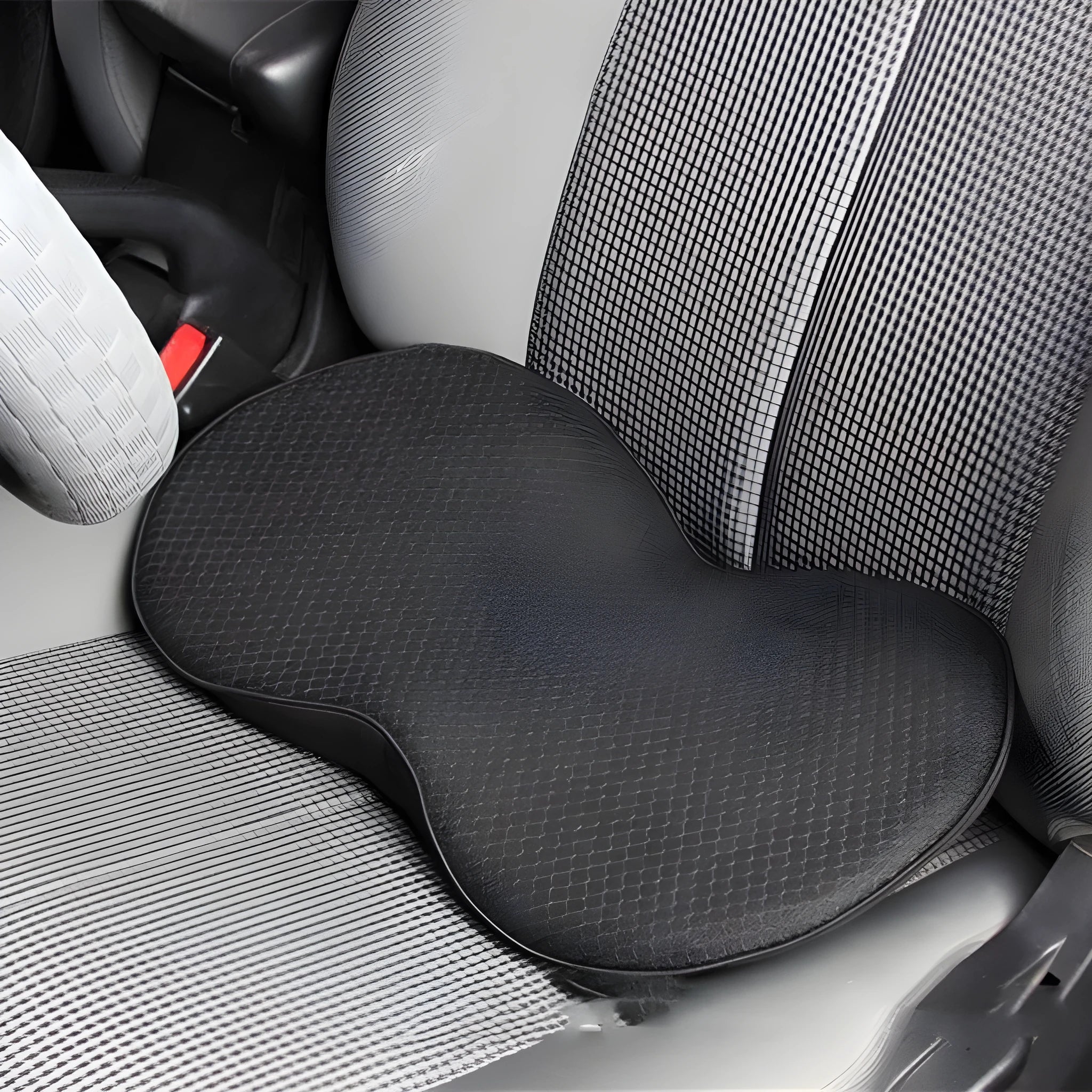 Flat black memory foam car seat cushion for increasing driving height.