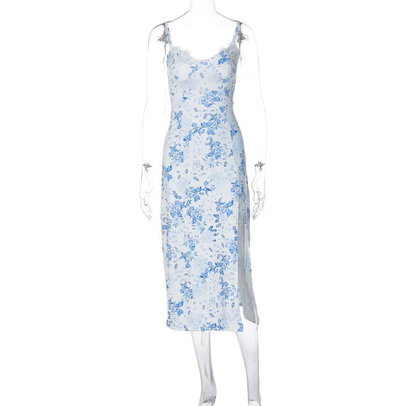 Women's long blue lace print dress with a high side slit and thin black suspender straps.