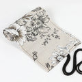 Black peony floral print canvas pencil roll bag unrolled to show 24 pencil sleeves