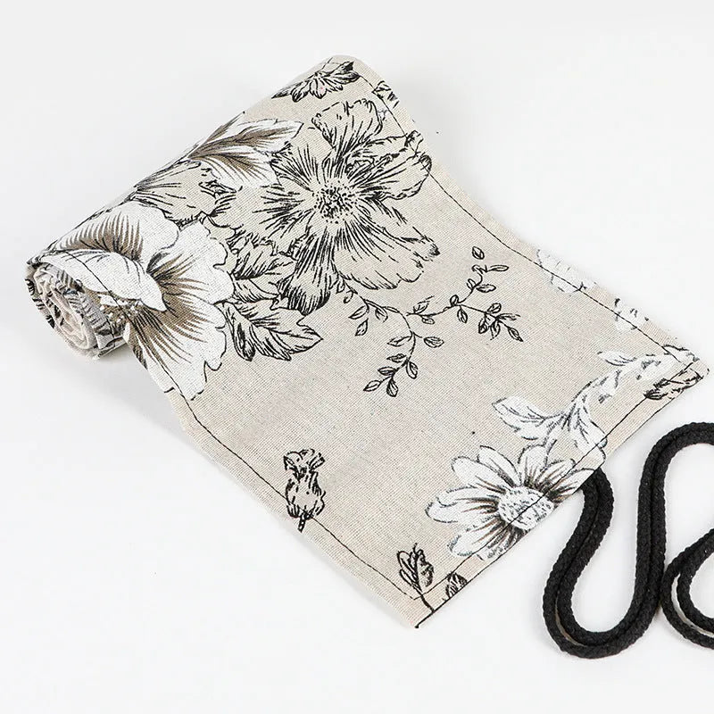 Black peony floral print canvas pencil roll bag unrolled to show 24 pencil sleeves