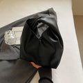 Casual dumpling shaped women's PU handbag in multiple colours showing phone compartment.