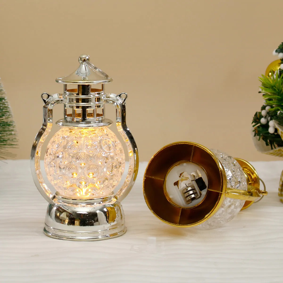 Small retro-style oil lamp LED night light in gold or silver finish on a table.
