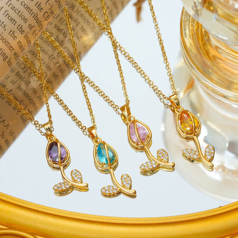 Gold tulip pendant necklace with zircon stones on an adjustable O-ring chain, showing colour options.