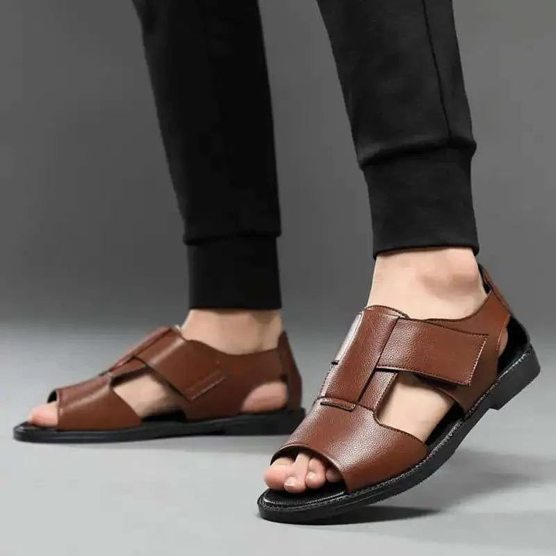 Men's black and brown leather open-toe sandals with a rubber sole on a neutral background.